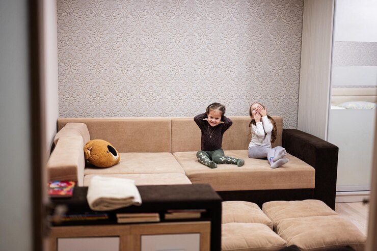 two sisters home living sofa laughing