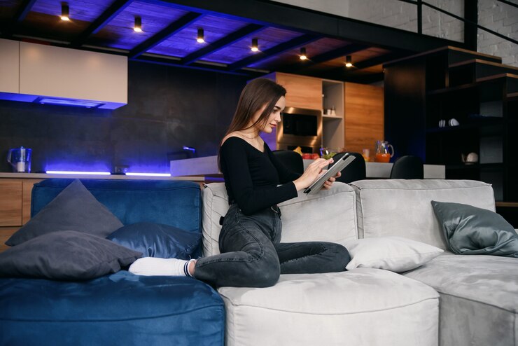 young woman with tablet PC on sofa